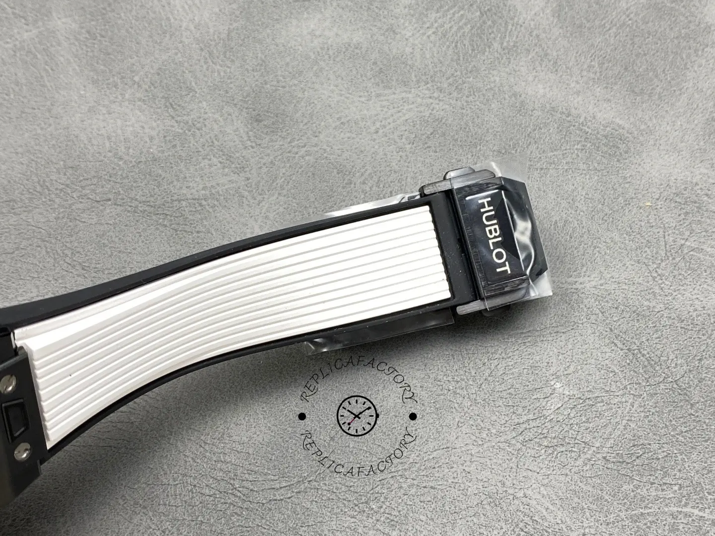 Clasp close-up of Hublot Big Bang Unico 441.CI.1171.RX showing HUBLOT buckle on white strap.