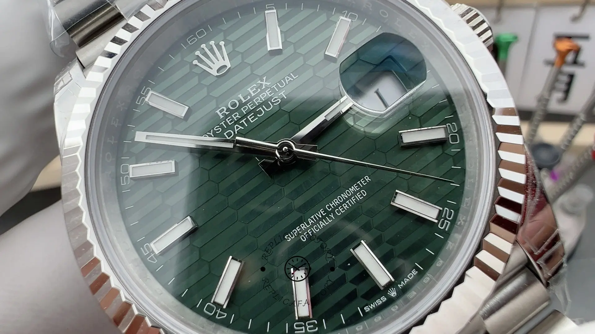 Close angled dial view of Rolex Datejust 41 126334-0030 showing mint green texture and fluted bezel.