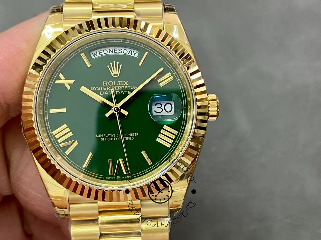 Handheld close-up of Rolex 228238-0061 showing green dial and fluted bezel.