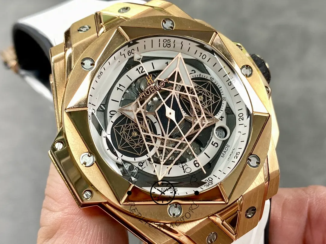 Hand-held view of Hublot 418.OX.2001.RX.MXM20 highlighting the geometric skeleton dial layout.