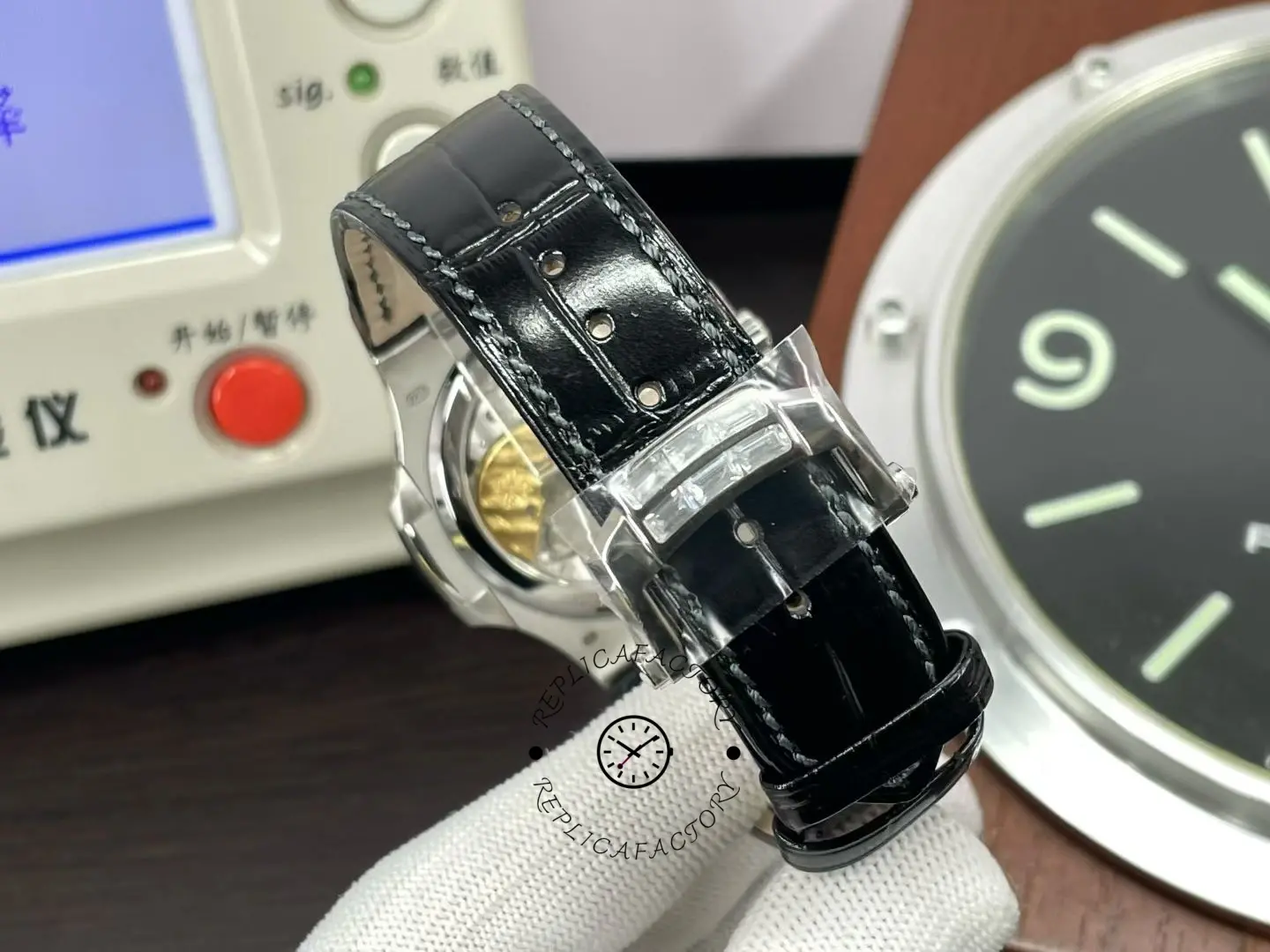 Rear view of Patek Philippe Nautilus 5724G 001 with black leather strap and deployant clasp.