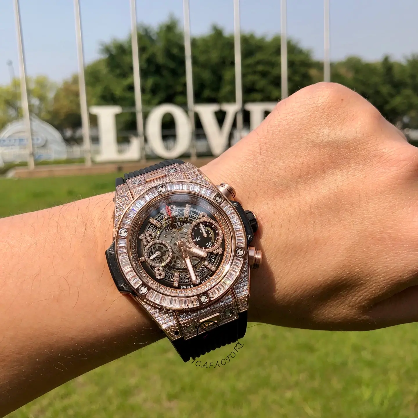 Wrist shot of Hublot 421.OX.1180.RX.0904 showing the full case profile with baguette bezel and black rubber strap.