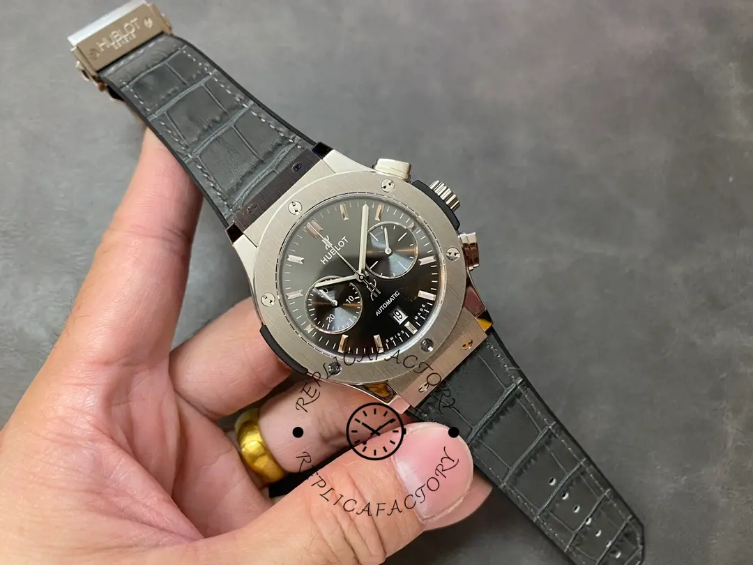 Hand-held full view of Hublot 521.NX.7071.LR showing case and strap proportions.