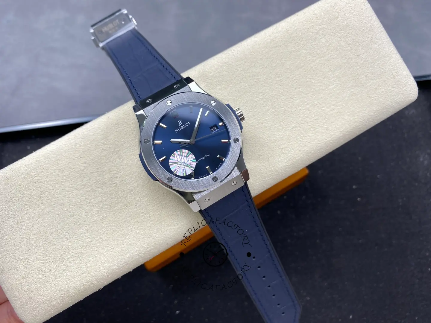 Full watch laid on box: Hublot Classic Fusion 542.NX.7170.LR with blue dial and blue strap.