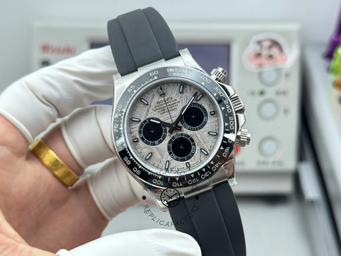 Handheld front view of Rolex Daytona 116519 showing meteorite dial and black contrasting registers.