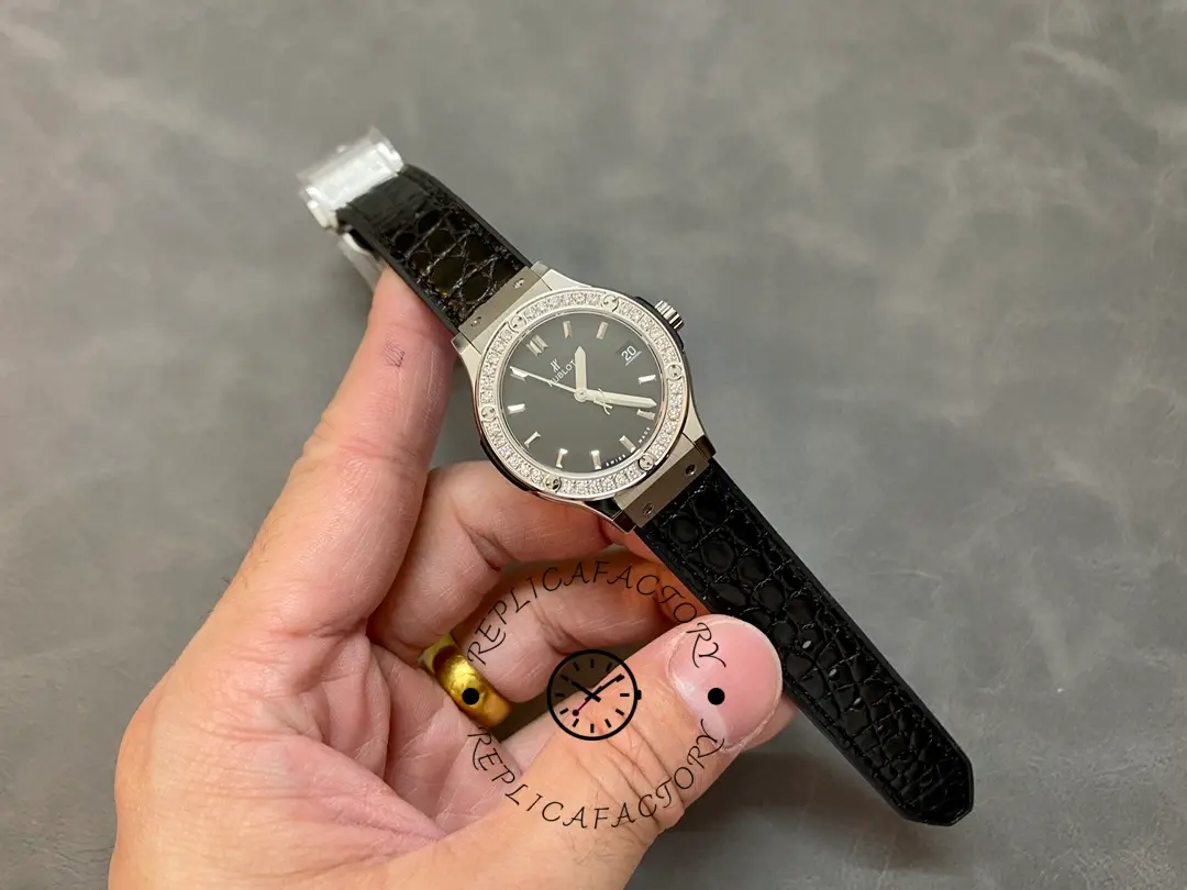 Hublot Classic Fusion 581.NX.1171.LR.1104 full strap shot, watch held in hand showing size on wrist line.