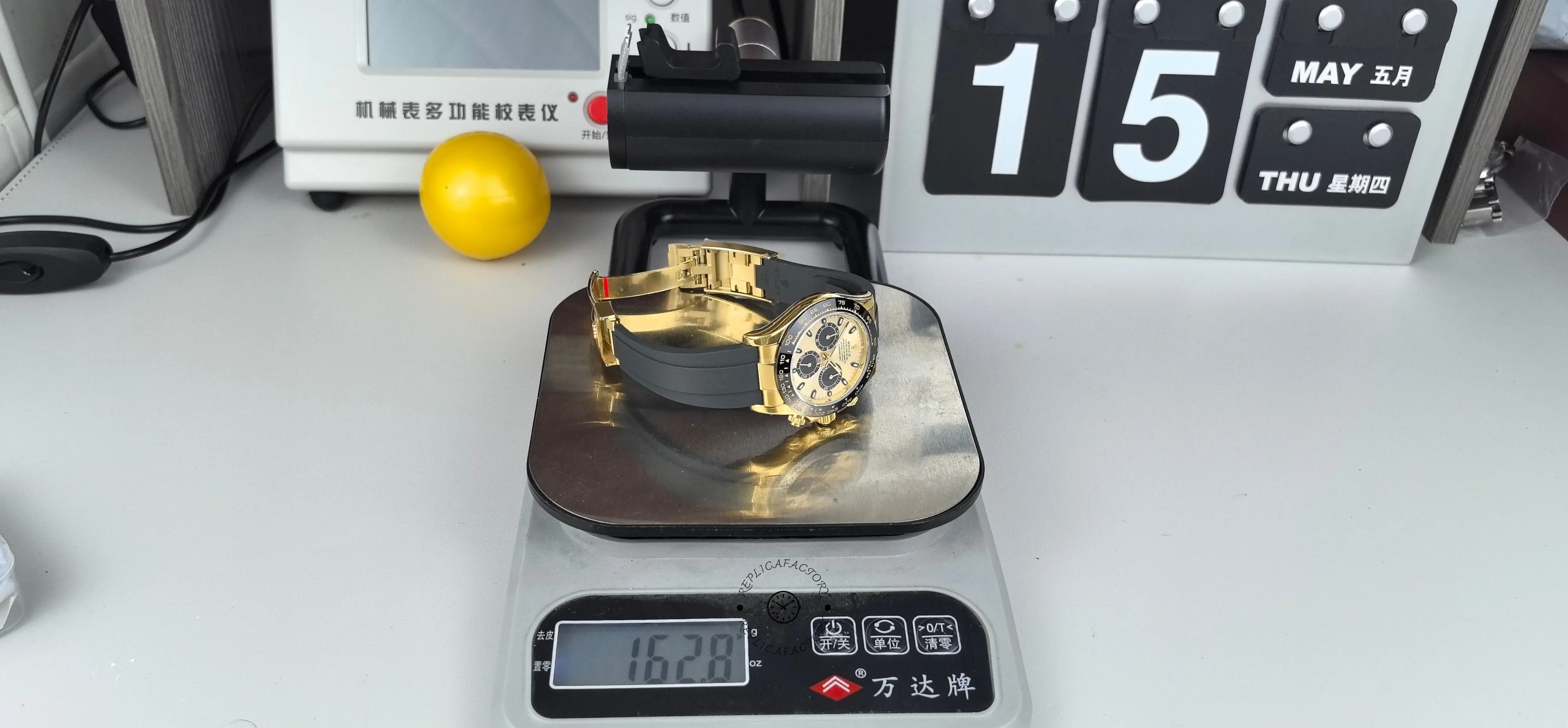 Wide shot of Rolex Daytona 116518LN placed on a digital scale with Oysterflex strap open.