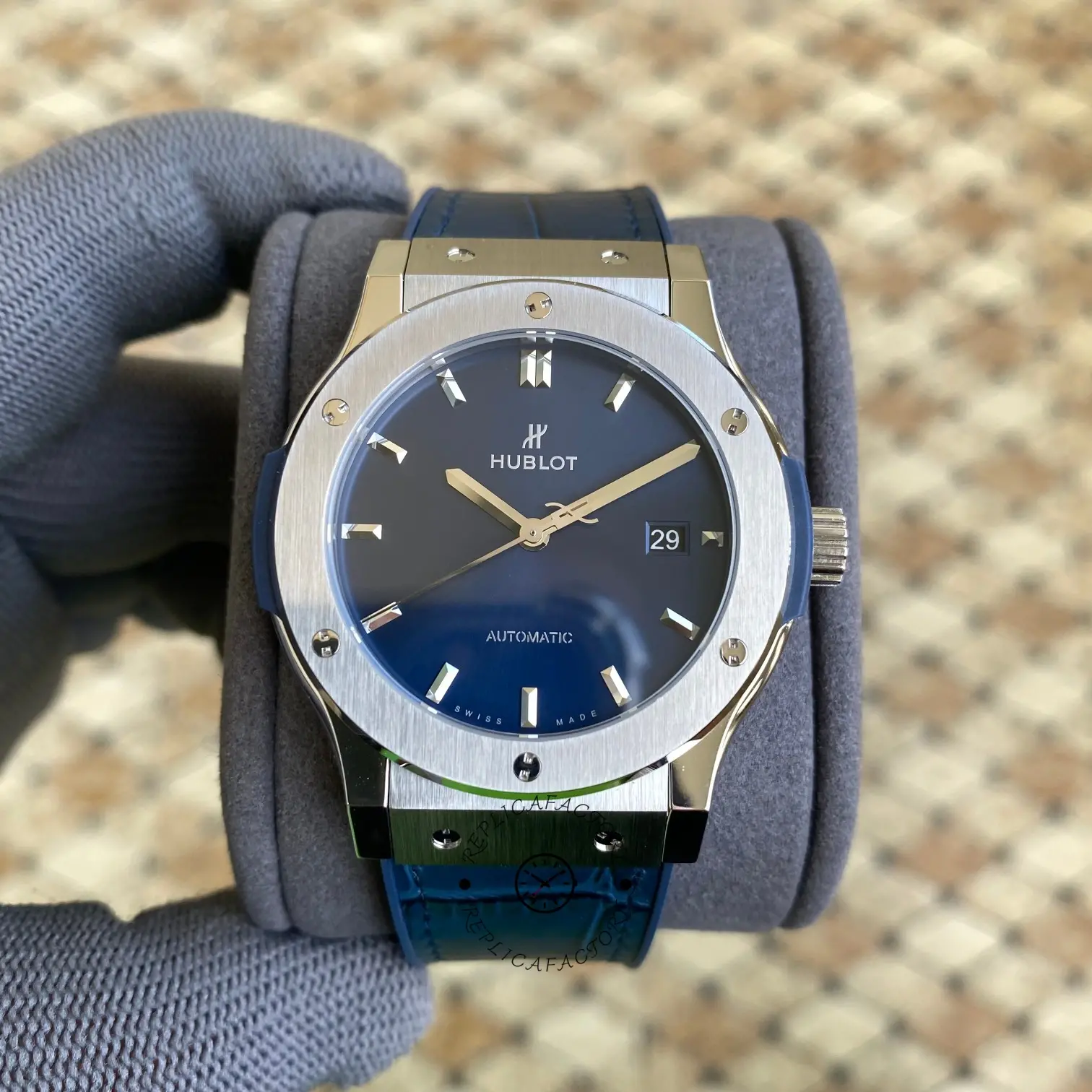 Glove-hand front view of Hublot Classic Fusion 511.NX.7170.RX showing blue dial and baton markers.