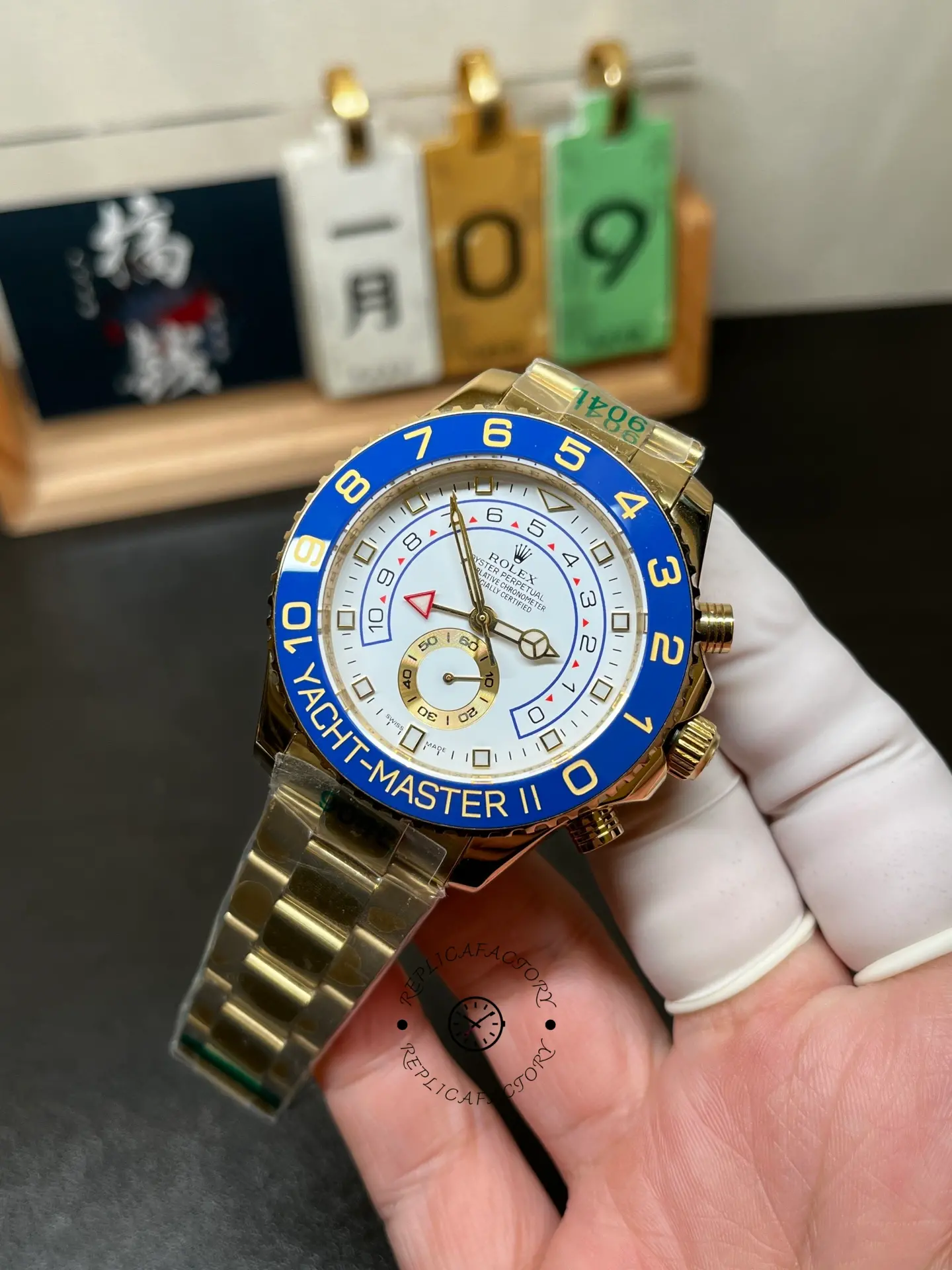 Angled front view of Rolex Yacht-Master II 116688 with white dial, blue bezel and gold-tone case.