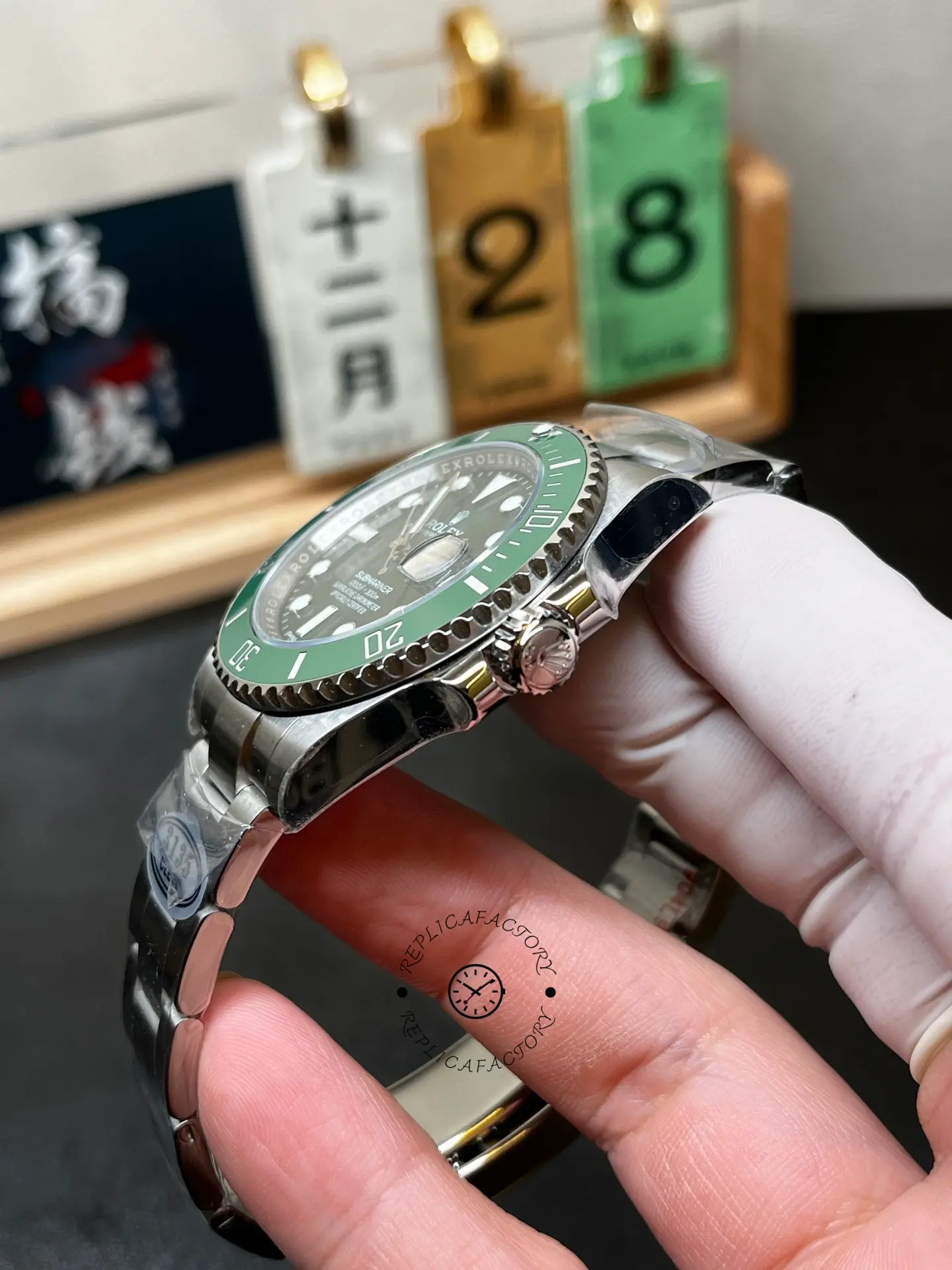 Crown-side angled view of Rolex 116610LV Submariner Date showing green bezel, case profile and crown guards.