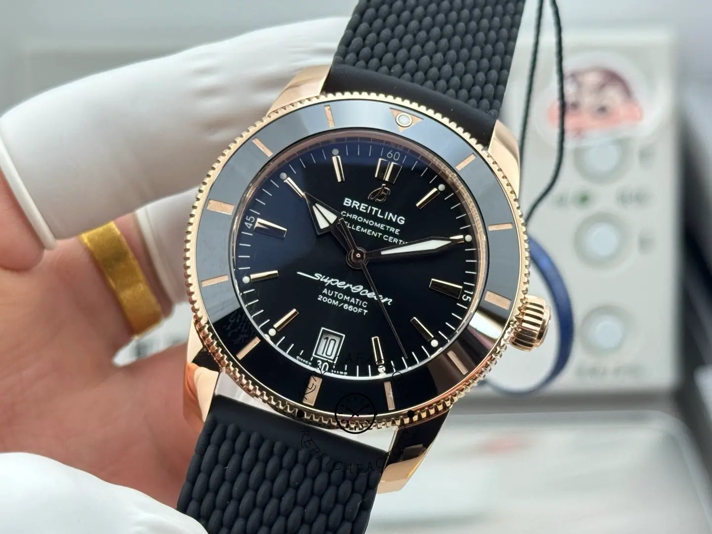 Breitling RB2010121B1S1, angled front view highlighting rose-gold case and black mesh strap texture.