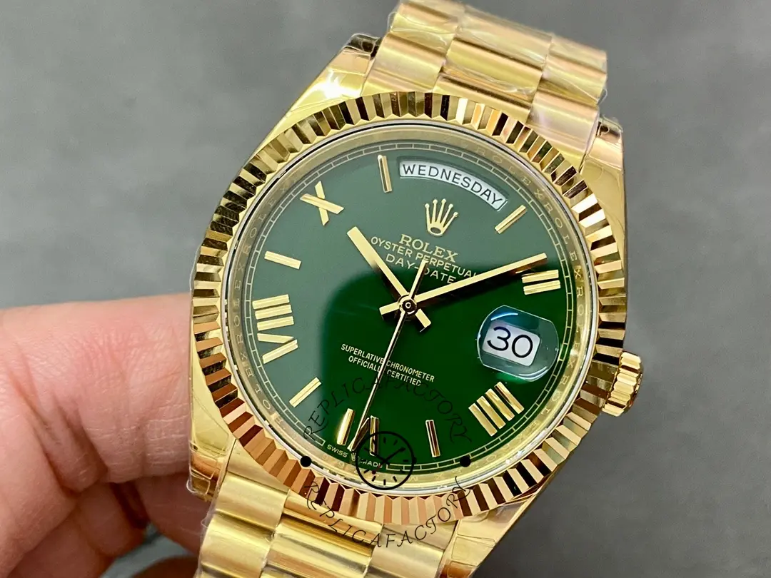 Handheld front angle of Rolex 228238-0061 with green dial and President bracelet.