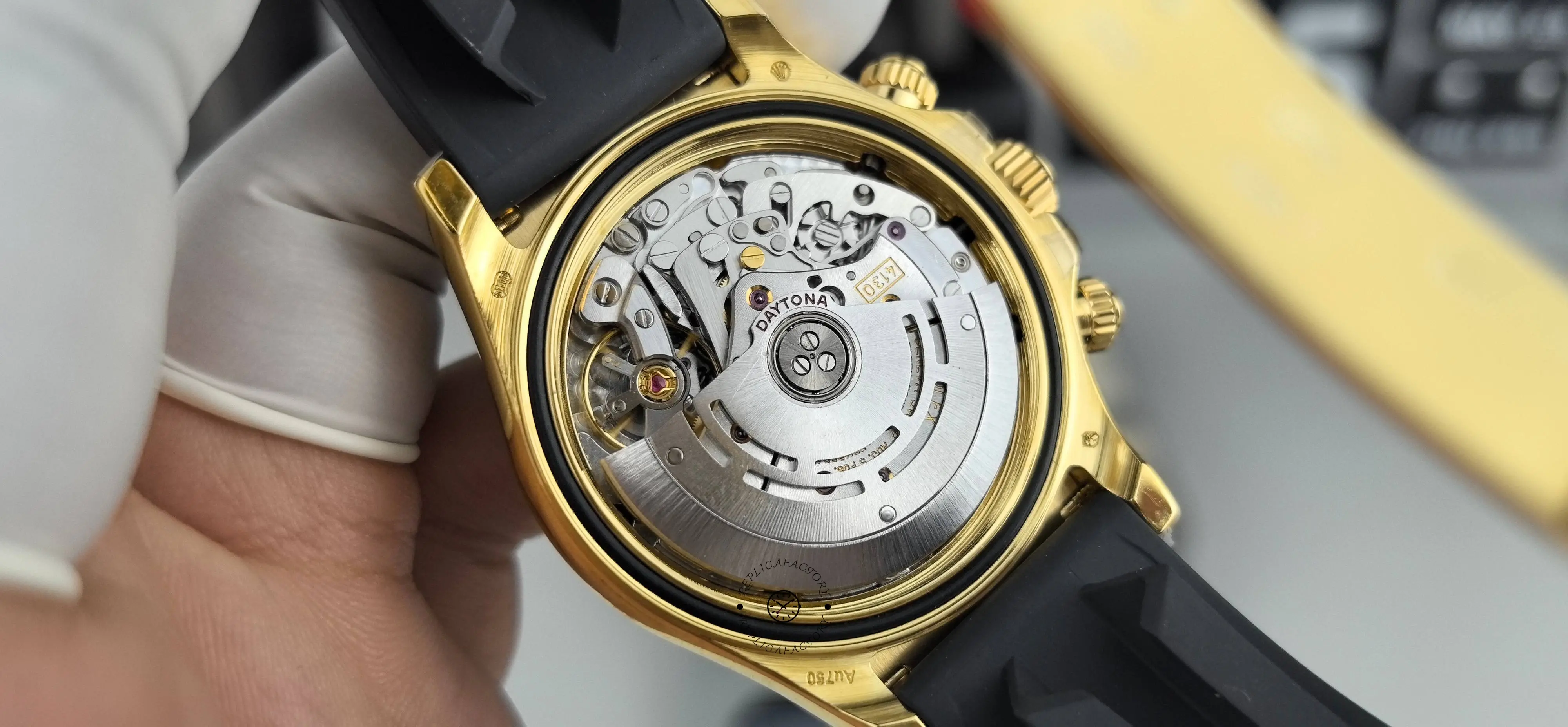 Open case back view of Rolex Daytona 116518LN showing automatic movement inside the gold-tone case.