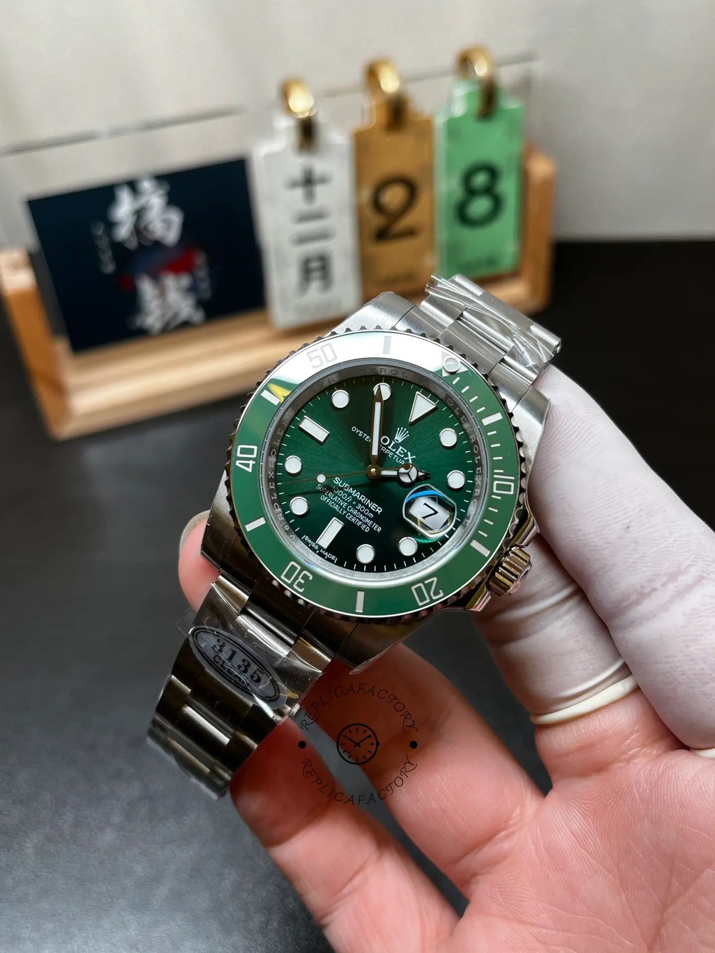 Angled hand-held front view of Rolex 116610LV Submariner Date with green sunburst dial and green bezel.