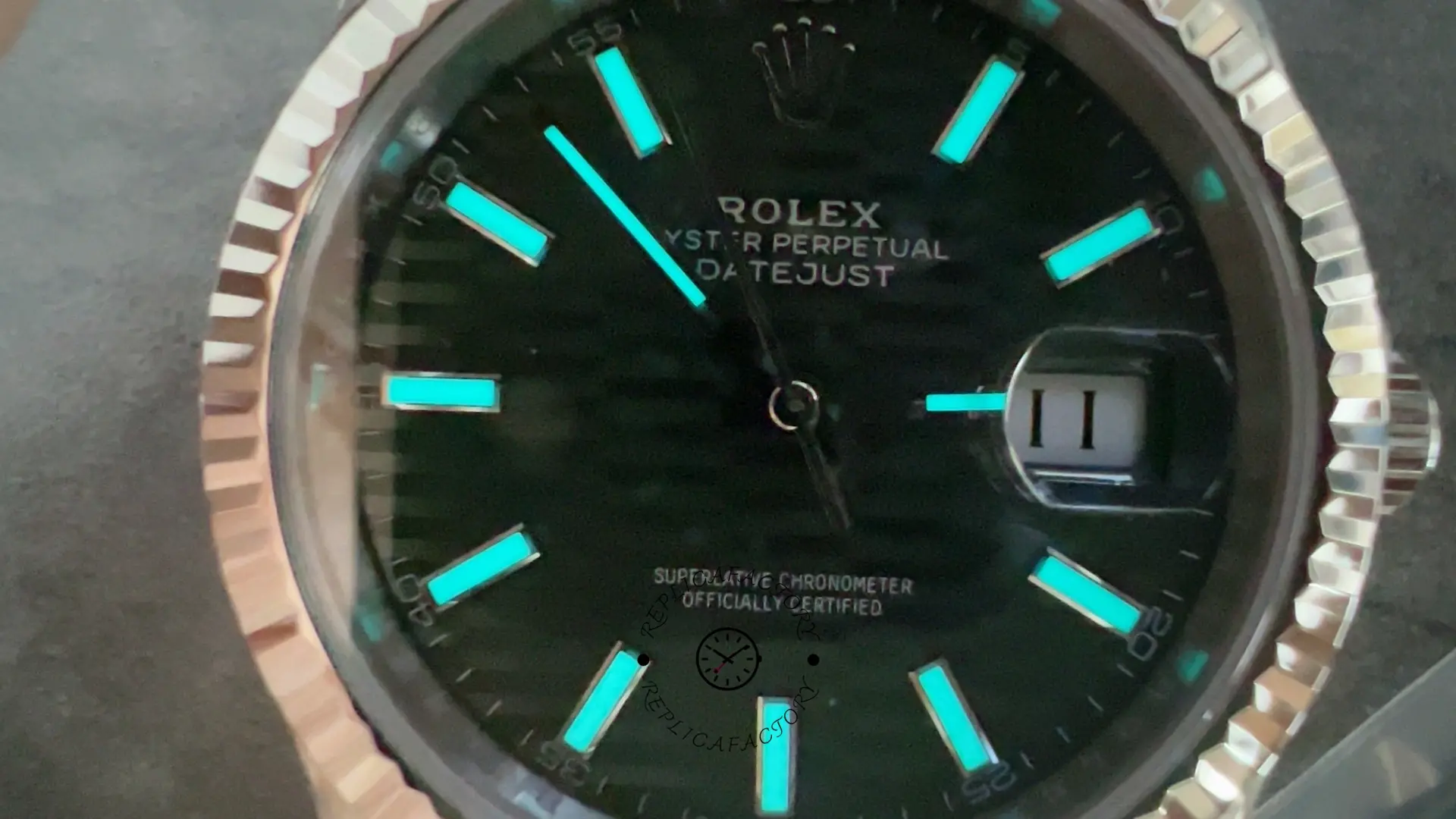 Lume shot of Rolex Datejust 41 126334-0030 showing glowing hour markers and hands on mint green dial.