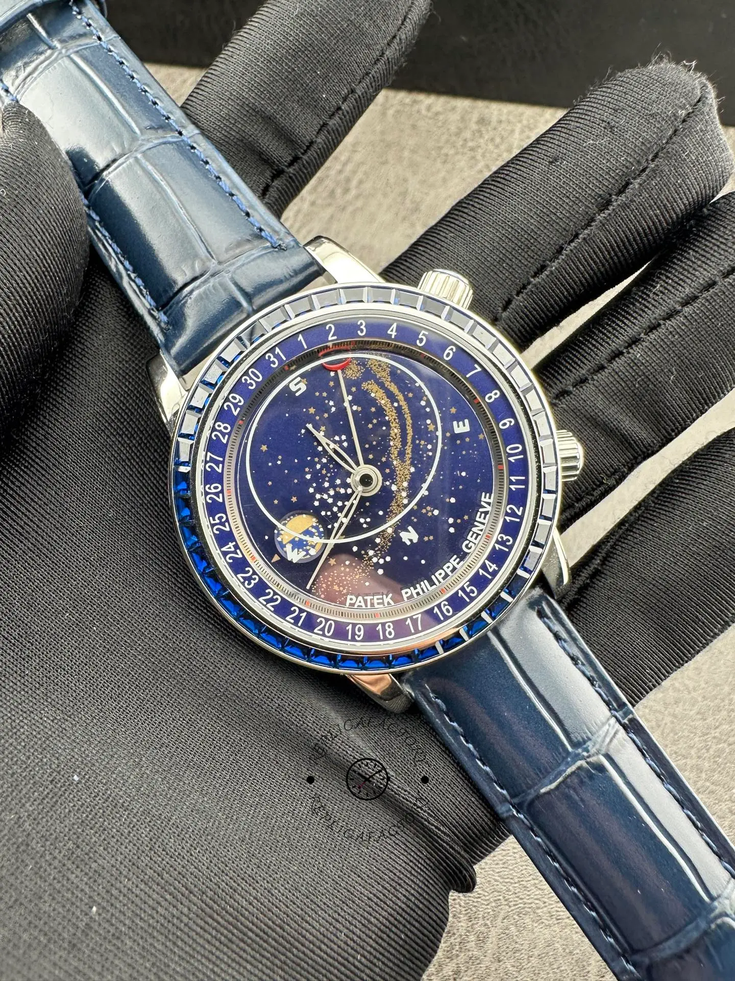 Full watch view of the 6104/11P-010 on blue leather strap with sapphire-set style bezel in focus.