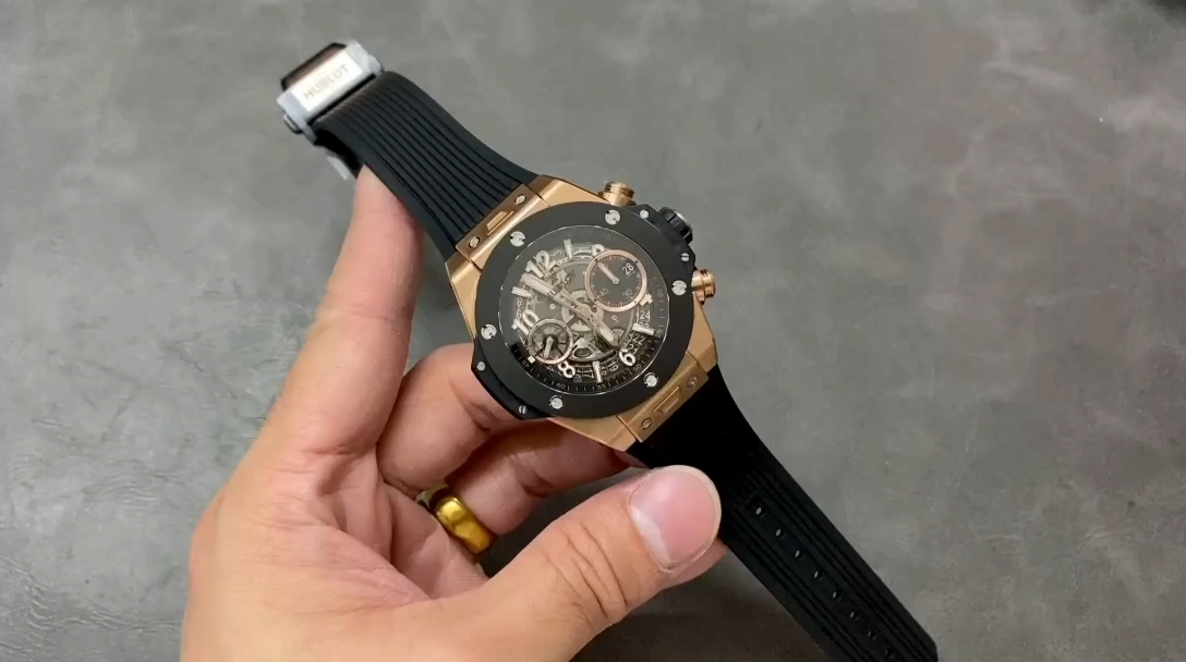 Hand-held shot of Hublot Big Bang 441.OM.1181.RX showing the full watch on black rubber strap. - Video
