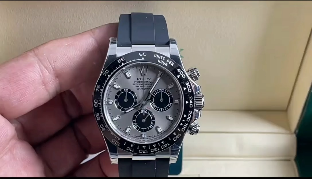 Video: hand holding Rolex Daytona 116519, grey dial and bezel visible. - Video