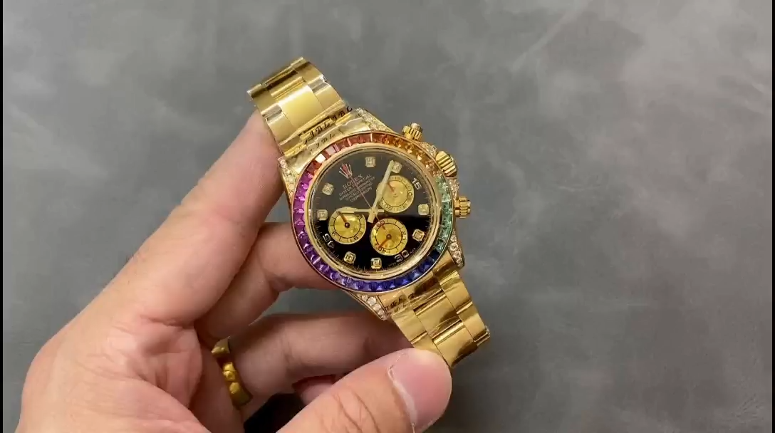 Hand-held video view of the Rolex Daytona 116598 40MM, rainbow bezel visible in hand. - Video