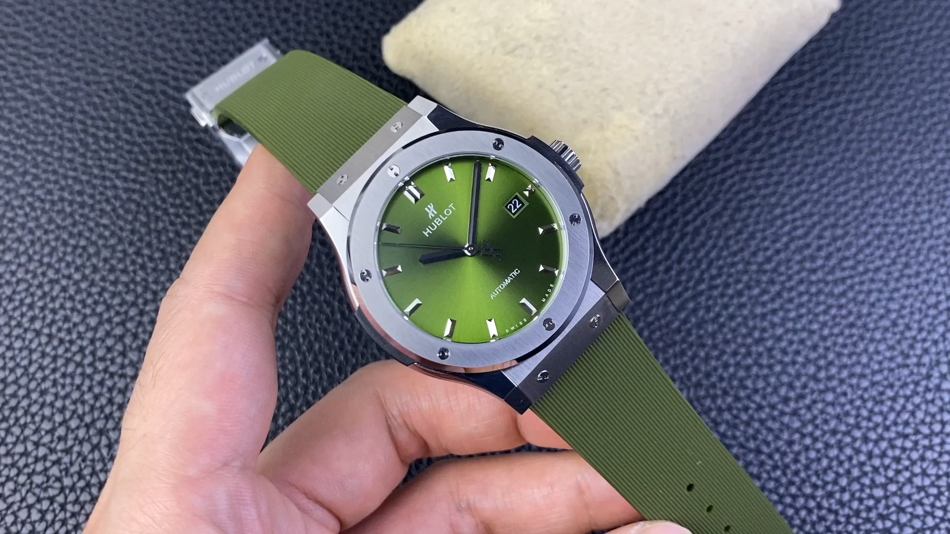 Hand-held video  of Hublot Classic Fusion 511.CO.1181.RX, green rubber strap detail. - Video