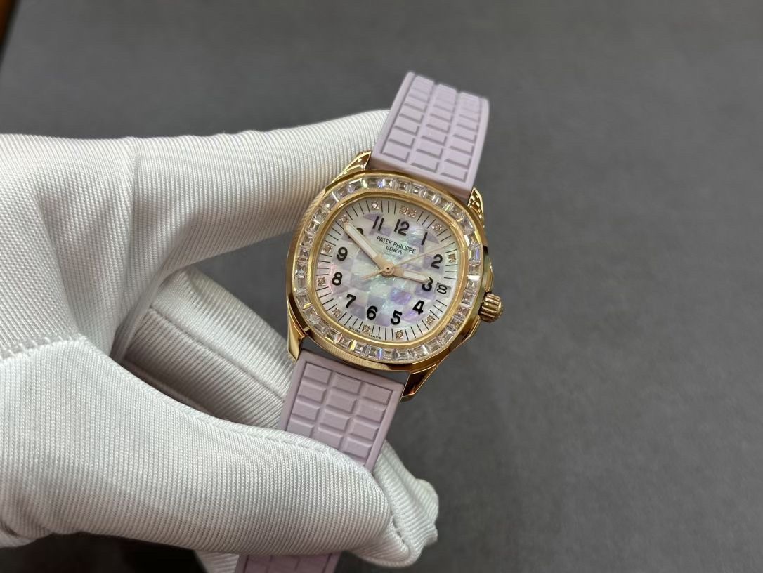 Hand-held close-up of Patek Philippe Aquanaut 5072R-001 showing diamond bezel and strap texture.