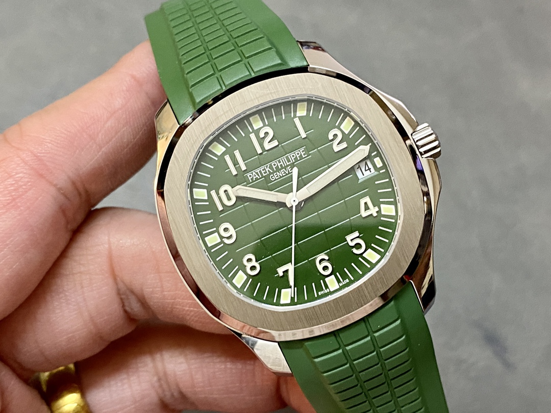 Hand-held close-up of Patek Philippe Aquanaut 5168G-010 showing dial pattern and hands.