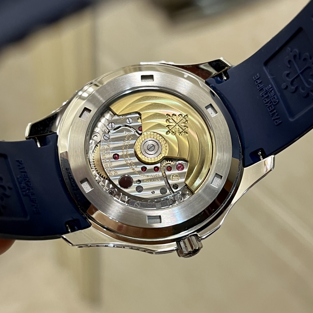 Exhibition caseback of Patek Philippe Aquanaut 5167/300G-010 showing gold rotor and movement details.