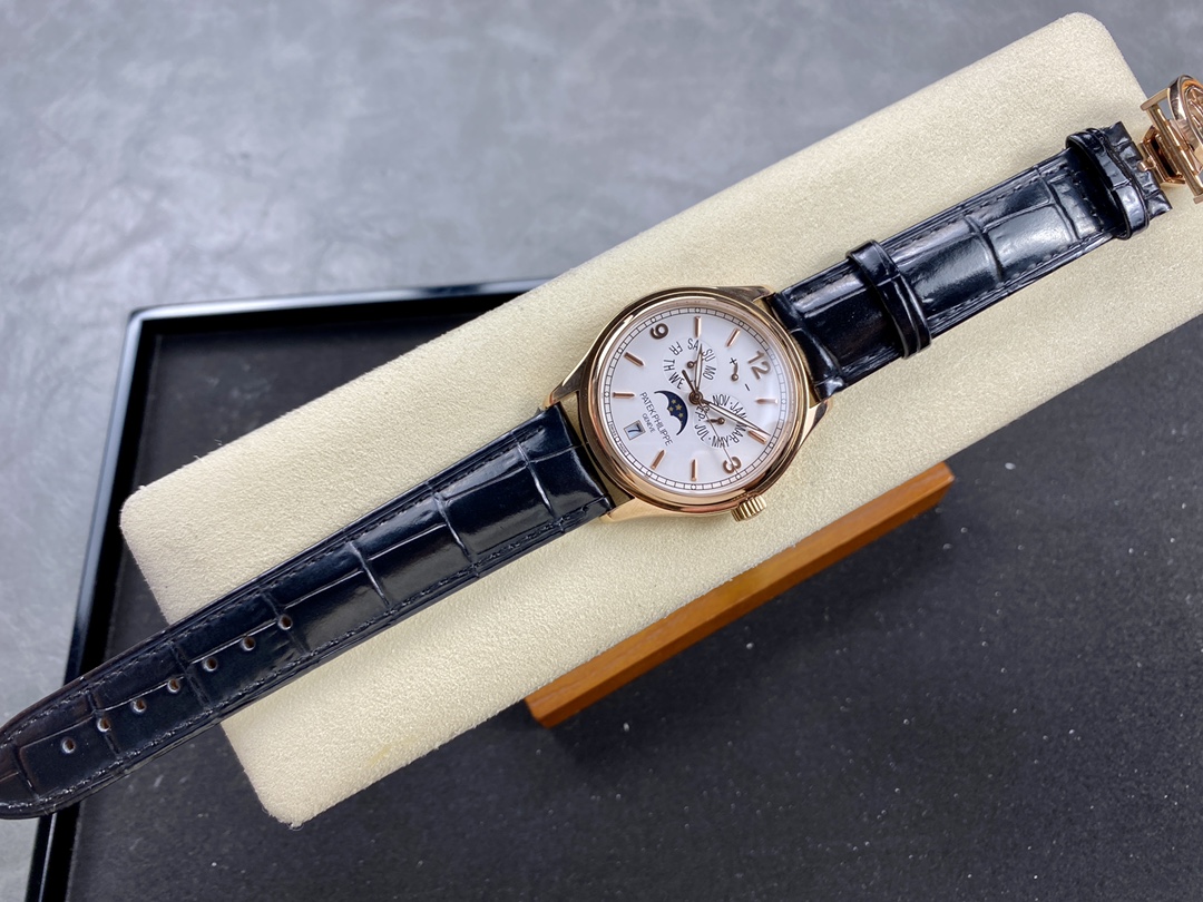 Watch on cushion in box: Patek Philippe 5146R-001 front view with cream dial and calendar display.