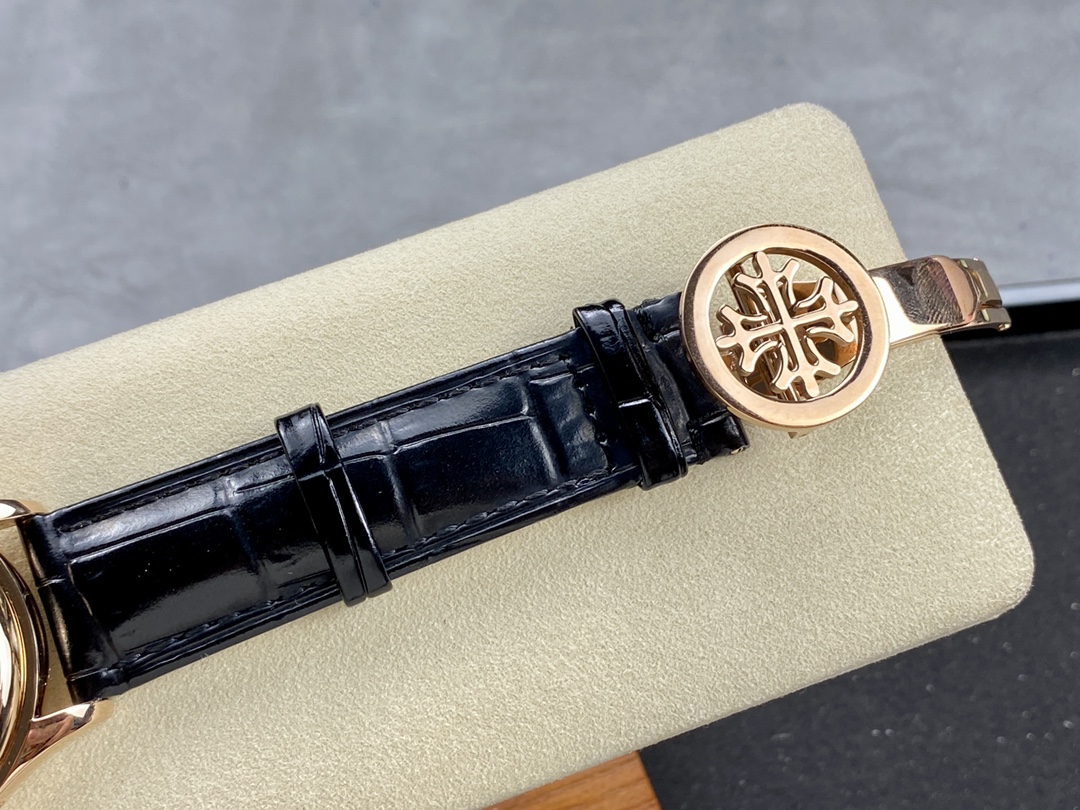 Buckle/clasp shot of the Patek Philippe 5146R-001 on strap, metal buckle detail on cushion.