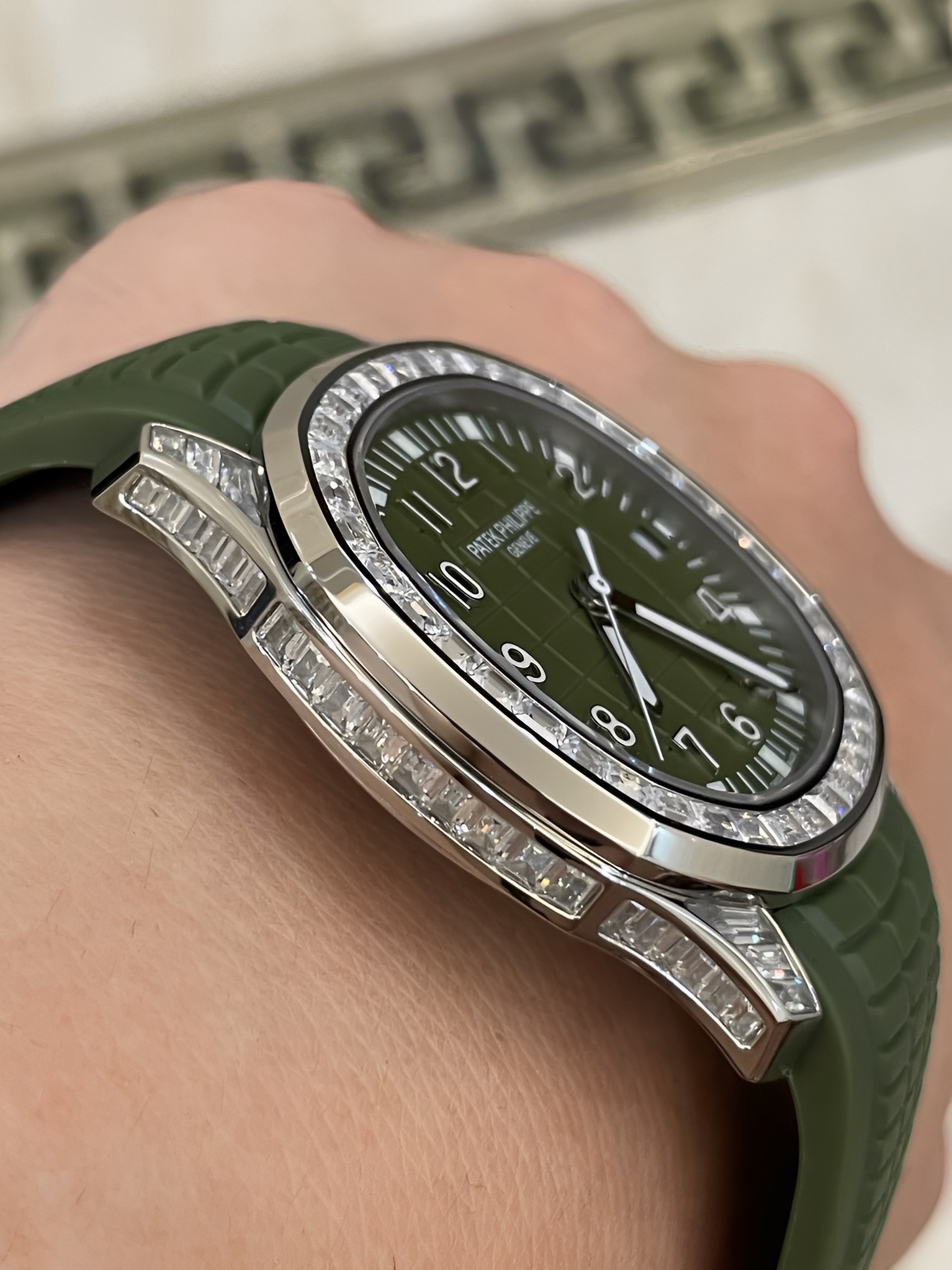 Close-up of Patek Philippe Aquanaut 5167/300G-010 showing bezel setting and case edge finishing.