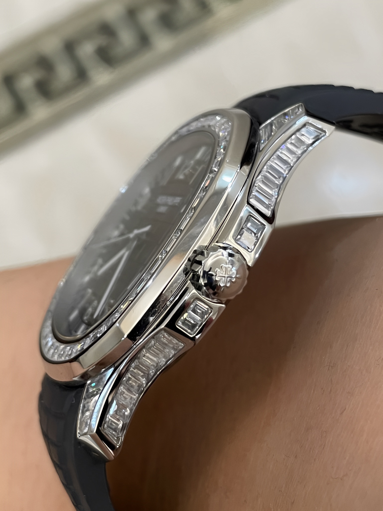 Side profile of Patek Philippe Aquanaut 5167/300G-010 showing crown side and polished case edge.