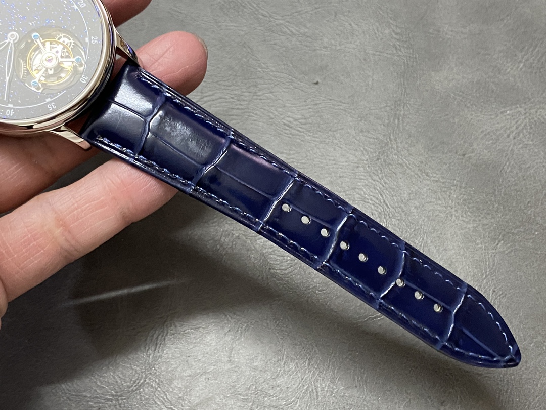 Strap detail of Patek Philippe 6102P 001 showing blue leather strap texture and stitching.