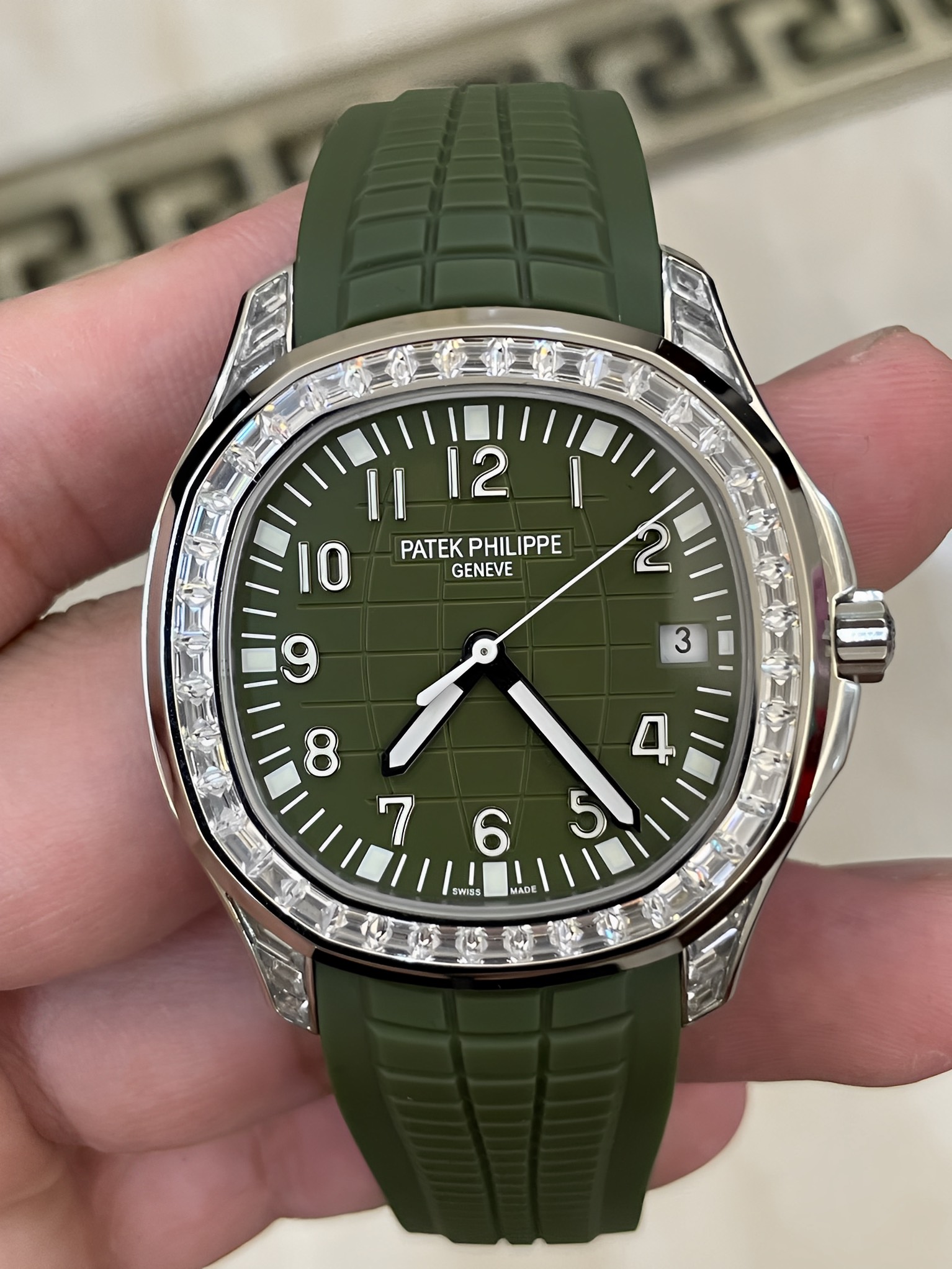 Front view of Patek Philippe Aquanaut 5167/300G-010, green dial with diamond-set bezel and green strap.
