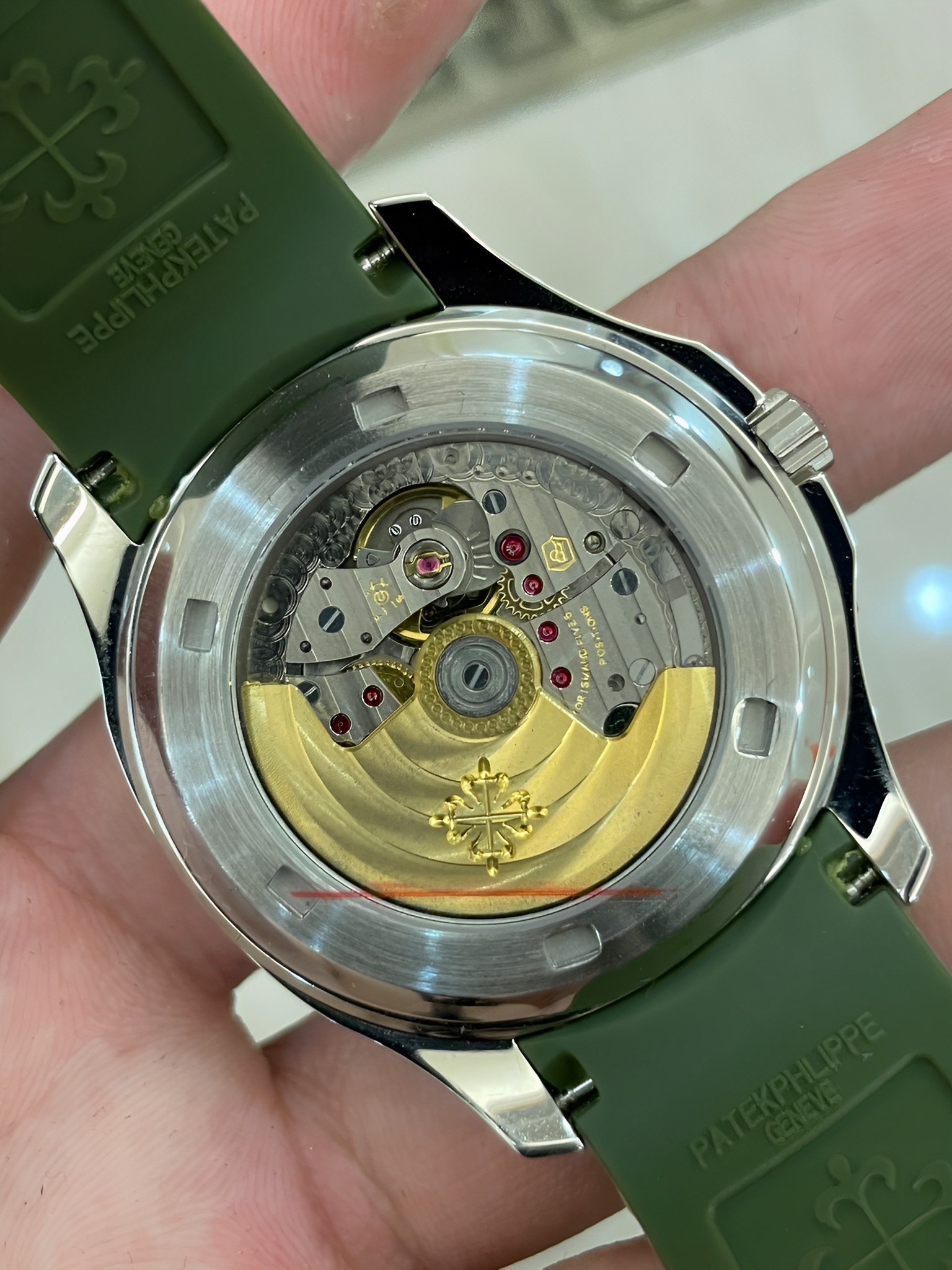 Caseback view of Patek Philippe Aquanaut 5167/300G-010 showing gold rotor and sapphire back.