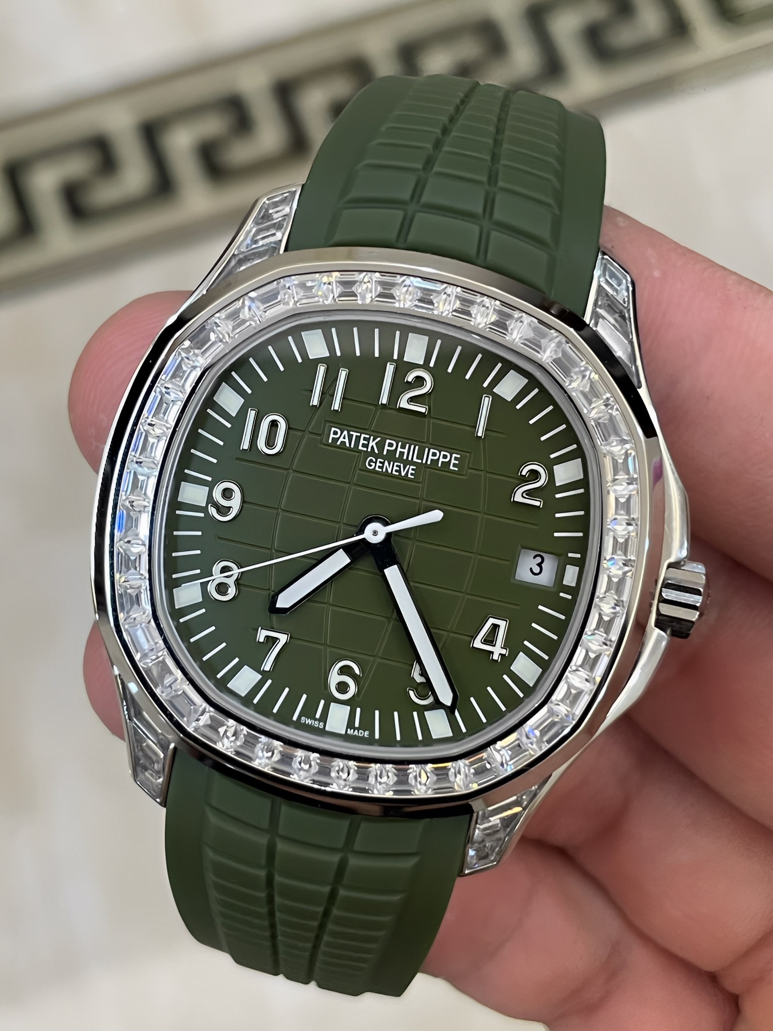 Angled view of Patek Philippe Aquanaut 5167/300G-010 highlighting diamond bezel sparkle on green dial.