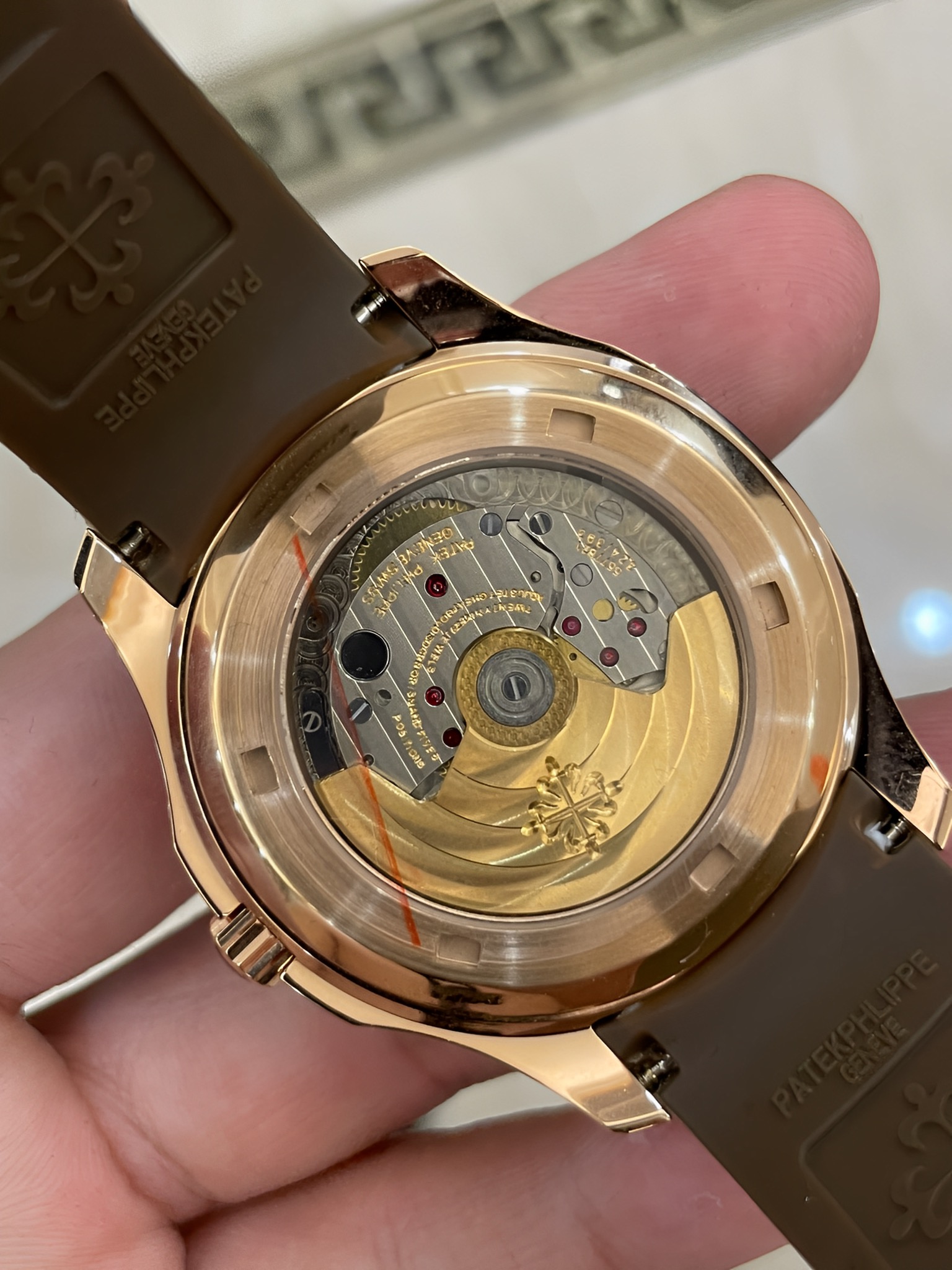 Exhibition caseback of Patek Philippe Aquanaut 5167/300G-010 showing gold rotor and movement finishing.