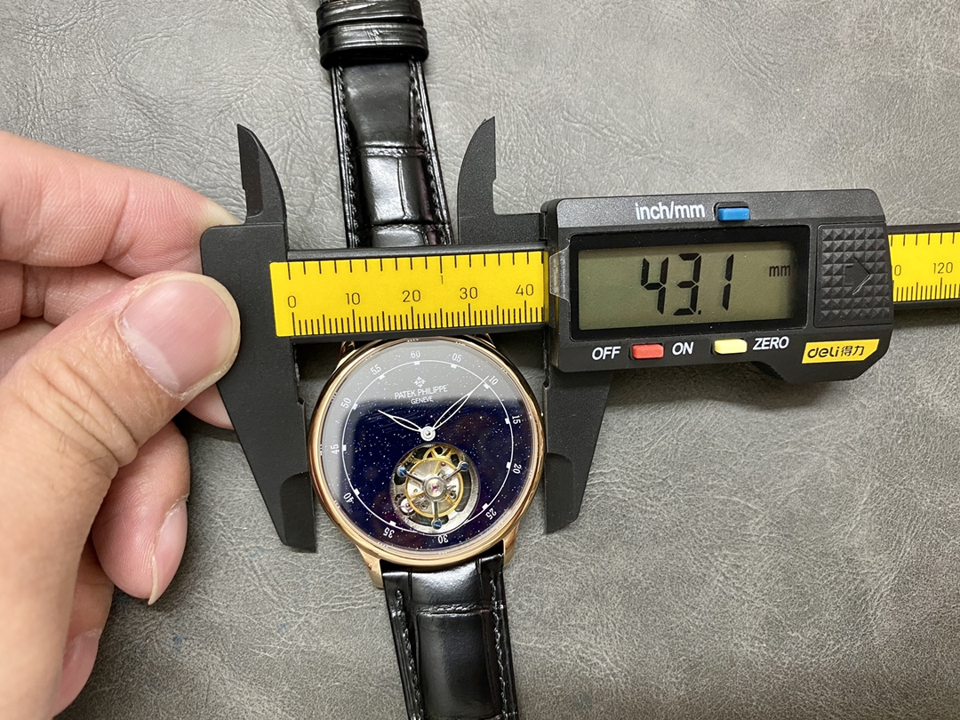 Size measurement of the Patek Philippe 6102P 001 with caliper, showing case diameter detail.