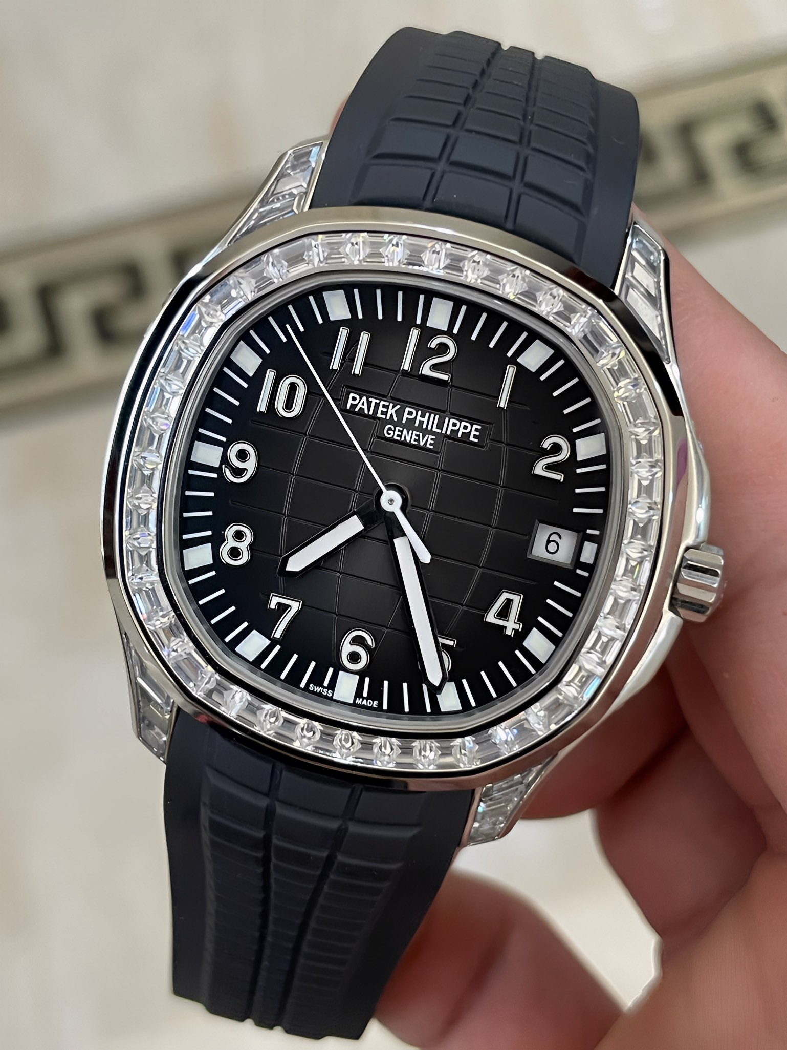 Close-up of Patek Philippe Aquanaut 5167/300G-010 showing black embossed dial pattern and minute track.