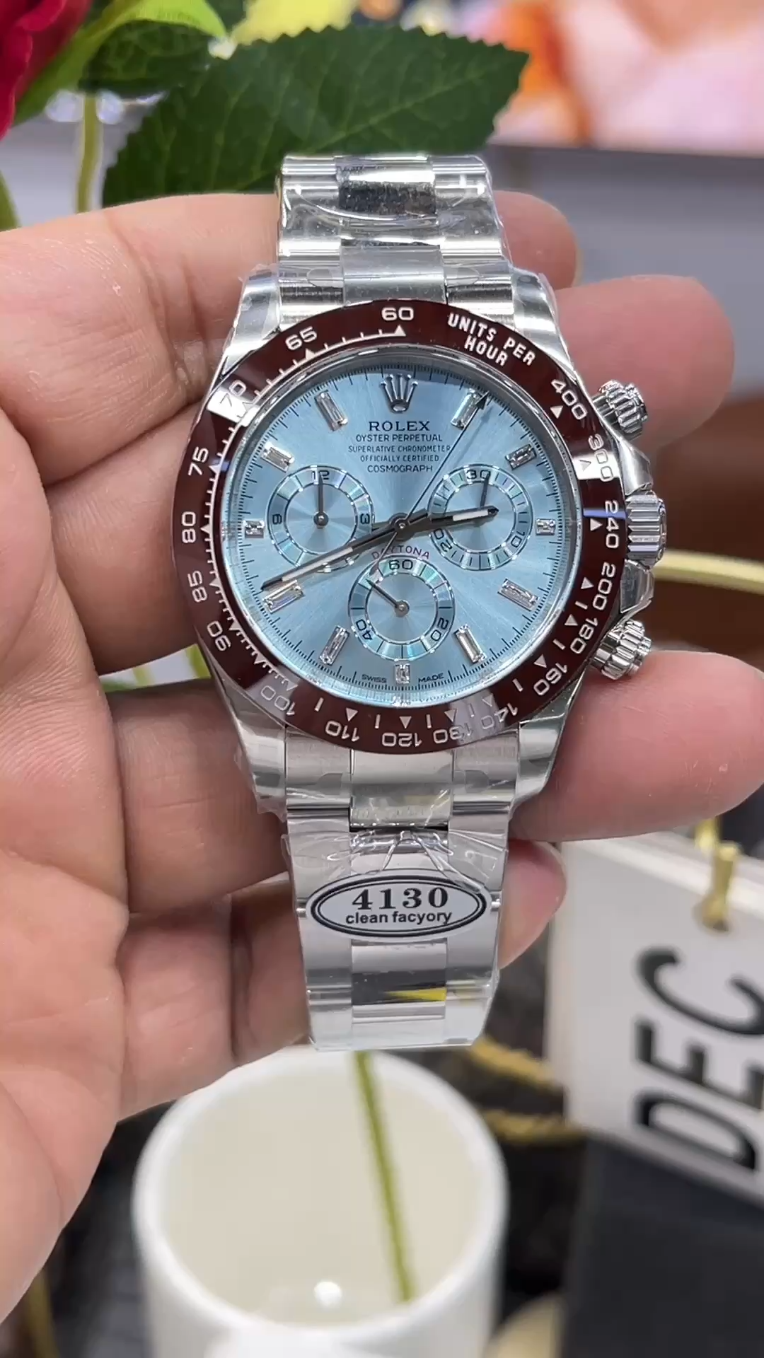 Video: hand holding Rolex Daytona 116506, ice blue dial and brown bezel visible. - Video