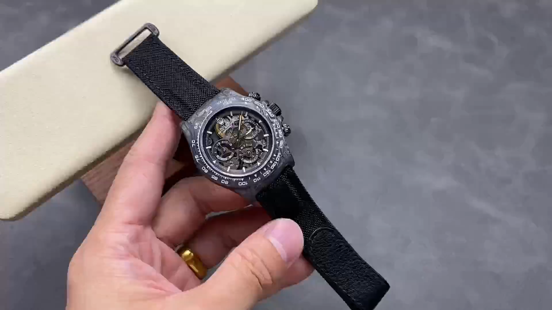 Rolex Daytona DIW video, handheld view of skeleton dial and black strap. - Video