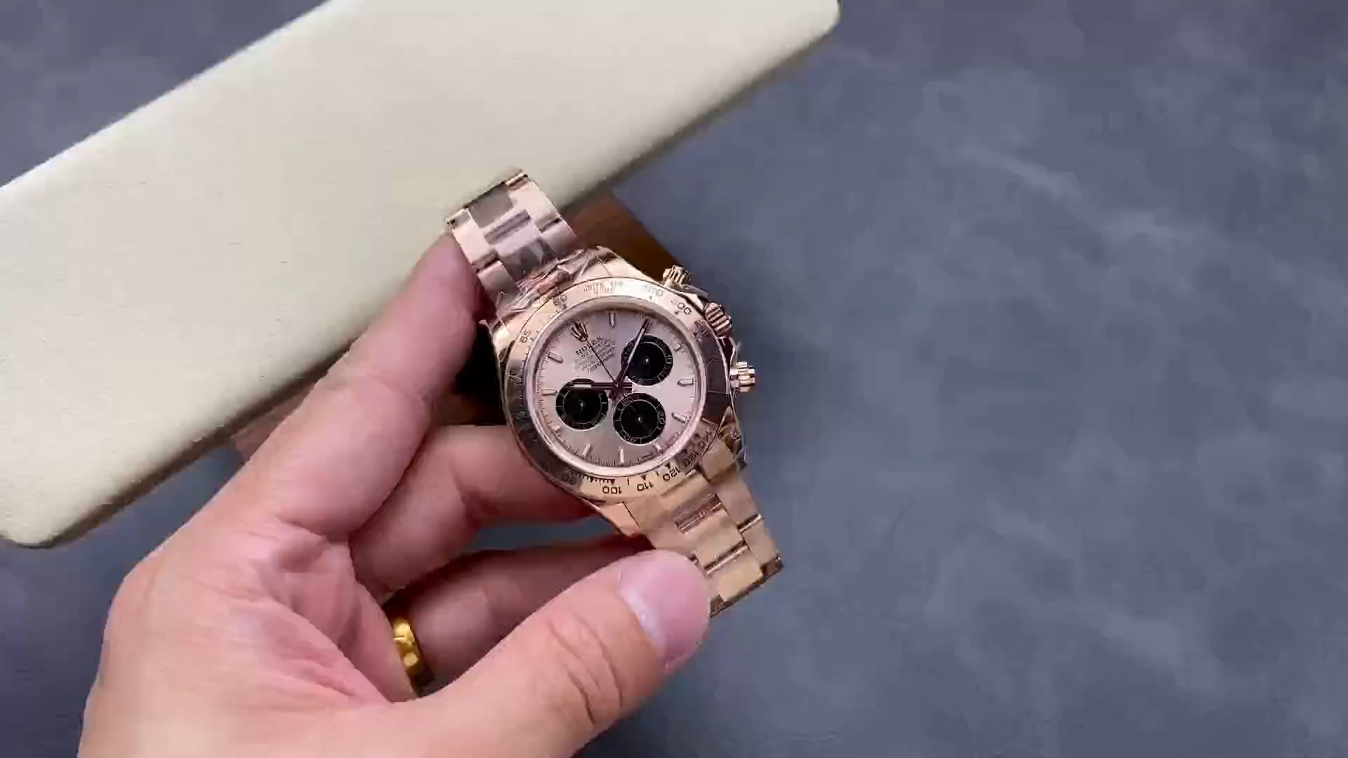 Hand-held video view of the Rolex Daytona 126505, bracelet and dial in frame.