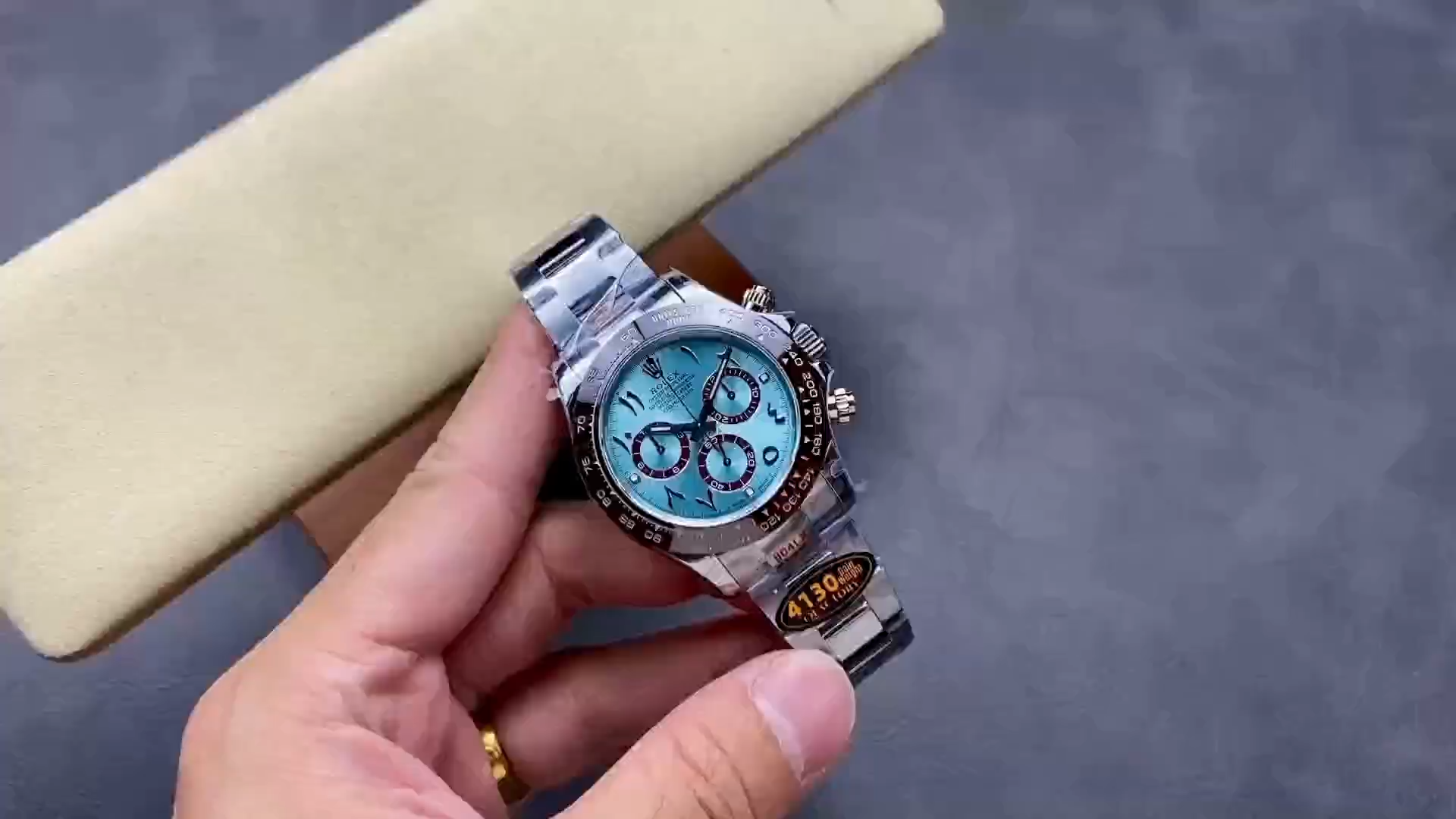 Video: hand holding Rolex Daytona Arabic 116506, ice blue dial and bezel visible. - Video