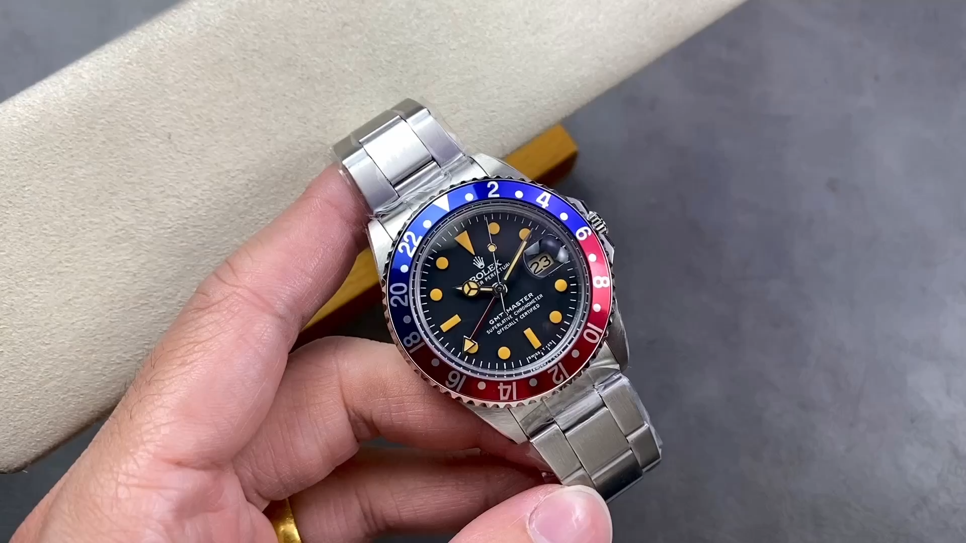 Rolex GMT-Master II 16710, video showing the watch held near cushion.