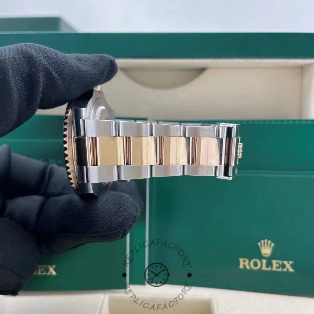 Bracelet view of Rolex GMT-Master II 126711CHNR, two-tone Oyster links in hand.