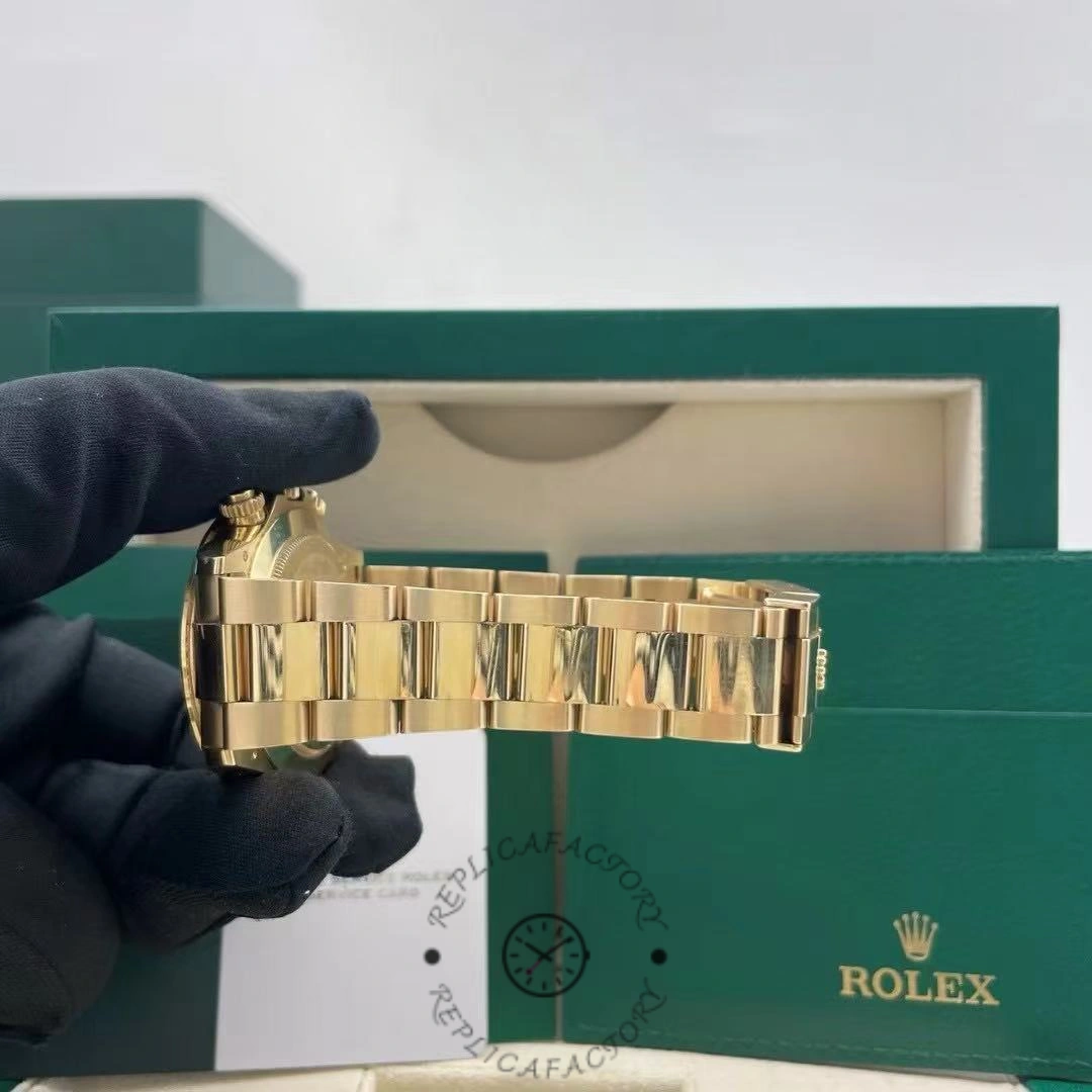 Hand-held bracelet view of Rolex Daytona 116508 showing clasp and links near box.