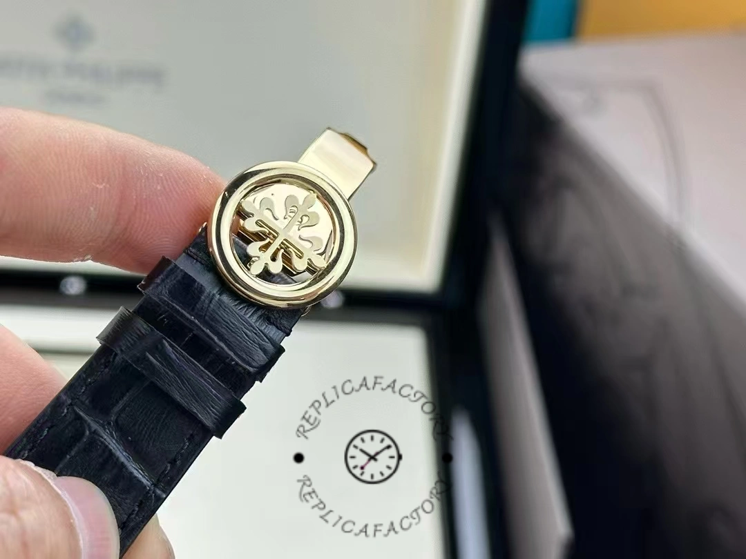 A close-up of the Patek Philippe 5146R-001 watch clasp, showing the engraved logo and the clasp outline.