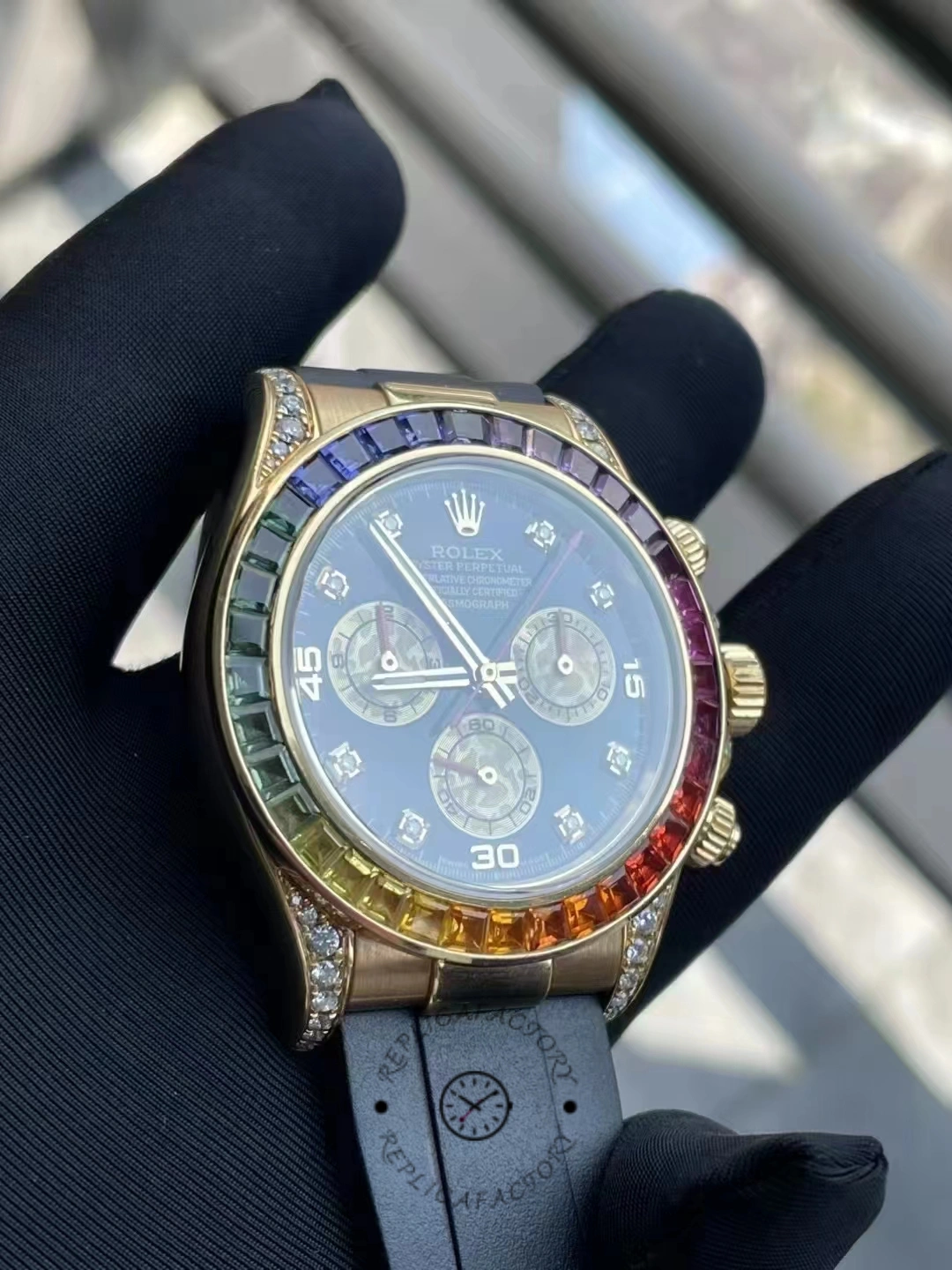 Front view of Rolex Daytona 116598RBOW under light showing blue-toned reflection on the dial.