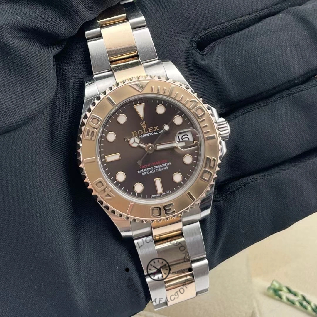Rolex Yacht-Master 268621 on glove, chocolate dial and bezel, Everose rolesor bracelet, front view.