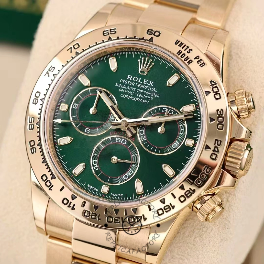 Dial macro of Rolex Daytona 116508 showing green dial and gold subdial rings.