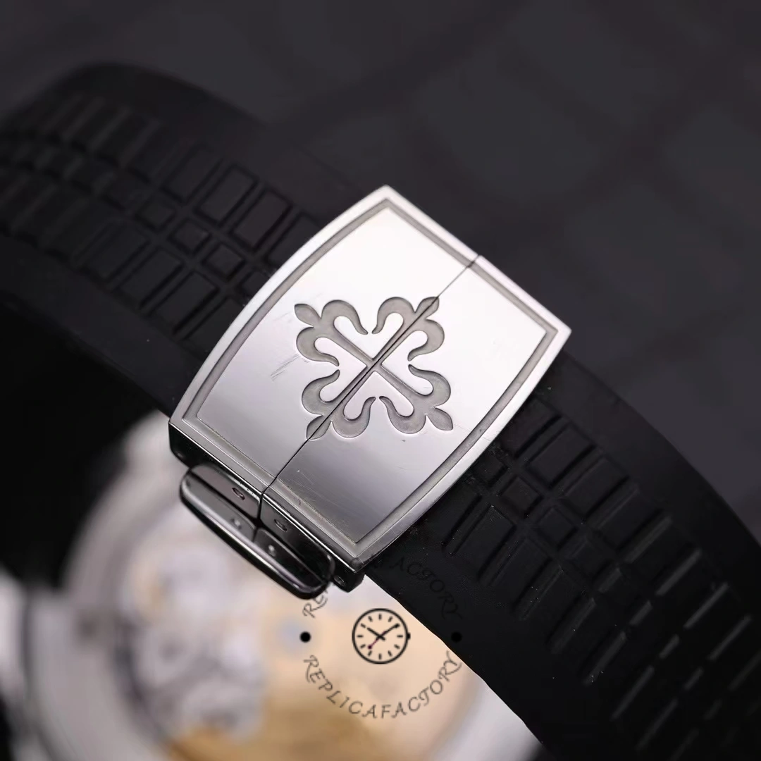 Strap end detail of the Patek Philippe Aquanaut 5164A-001 showing the logo plate on the rubber strap.
